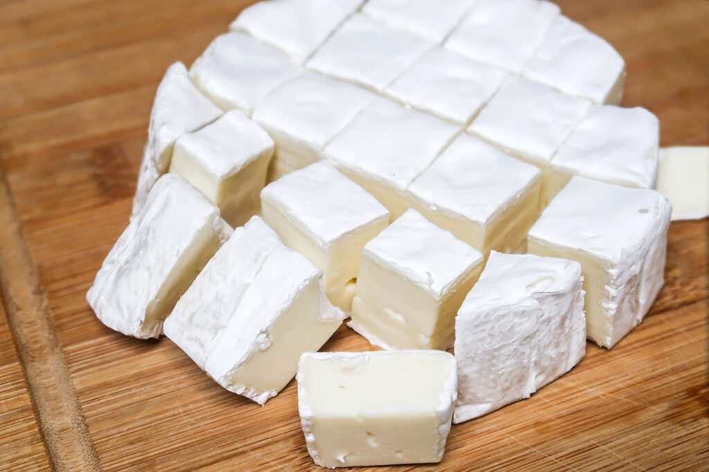 cubed brie bites on a cutting board